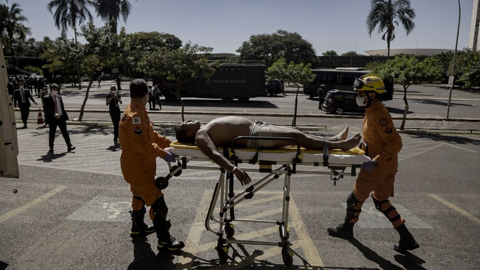 Indígena é socorrido por bombeiros após confronto em Brasília — Foto: Leo Otero