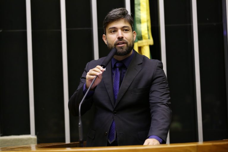 Deputado Pedro Lucas Fernandes discursa no Plenário da Câmara. Ele usa terno escuro, barba e bigode
